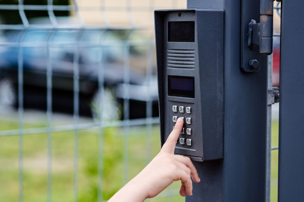 A Person is Pressing a Button on a Doorbell — Cambush Security Solutions NT in Palmerston, NT