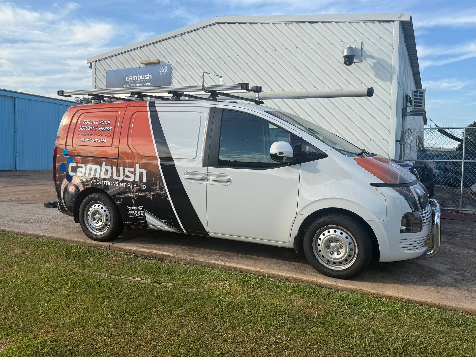 A White Van is Parked in Front of a Building — Cambush Security Solutions NT in Coconut Grove, NT