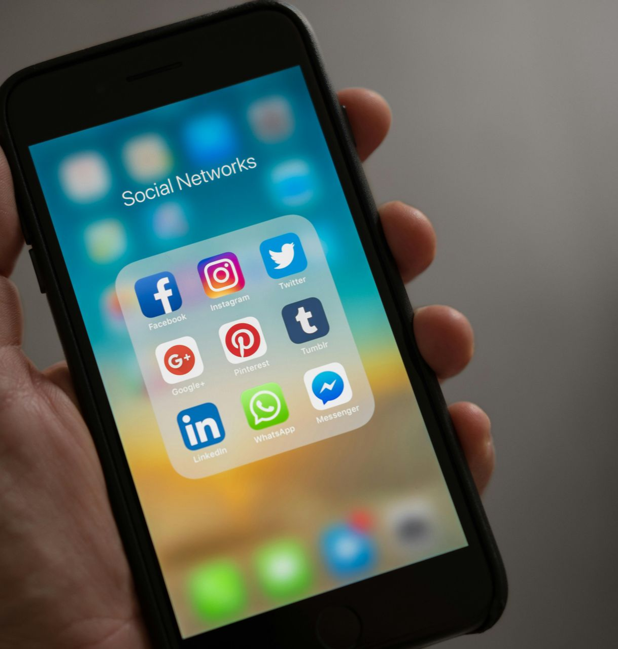 Person's hand holding a smartphone displaying a