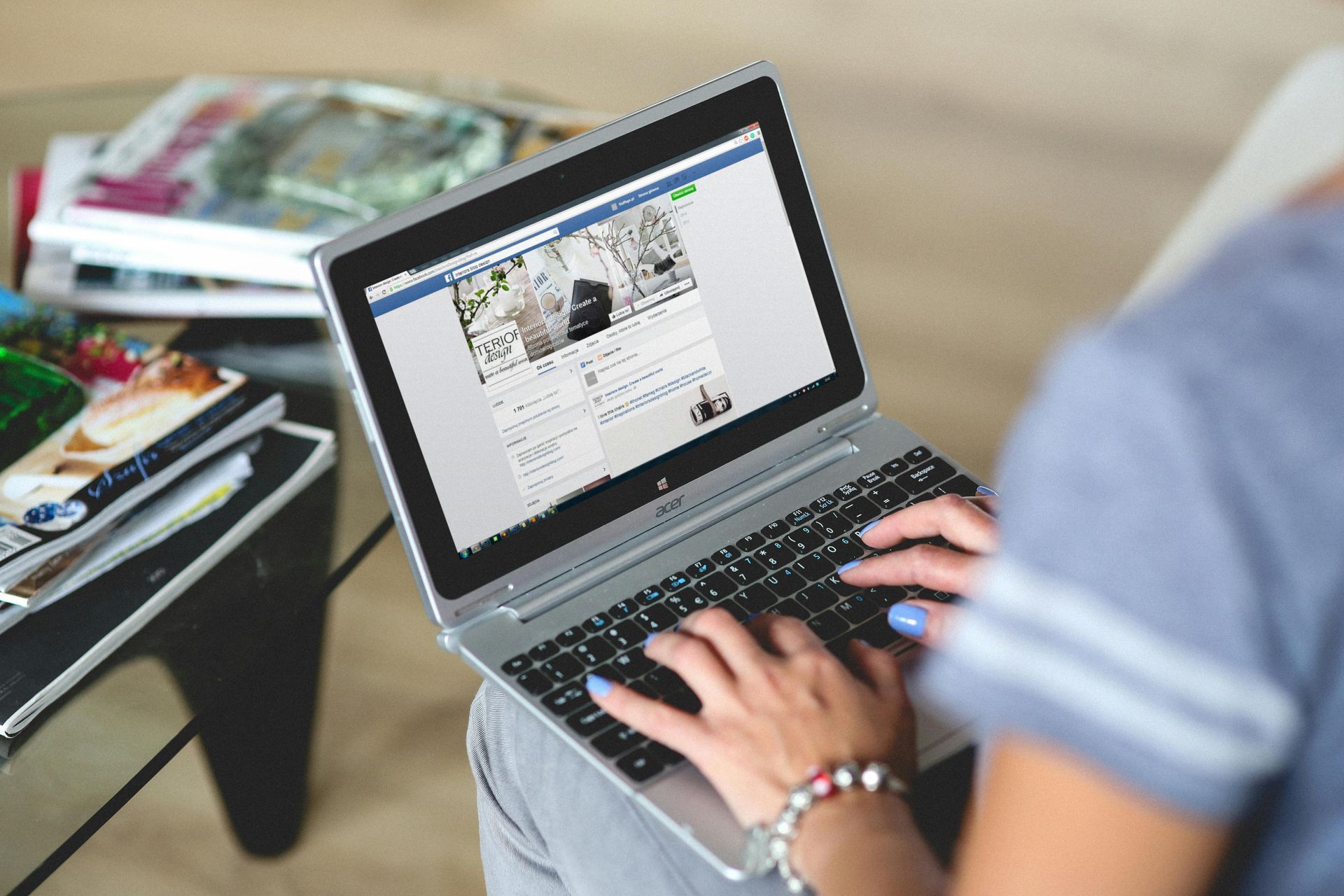 Young lady writing social media posts on laptop