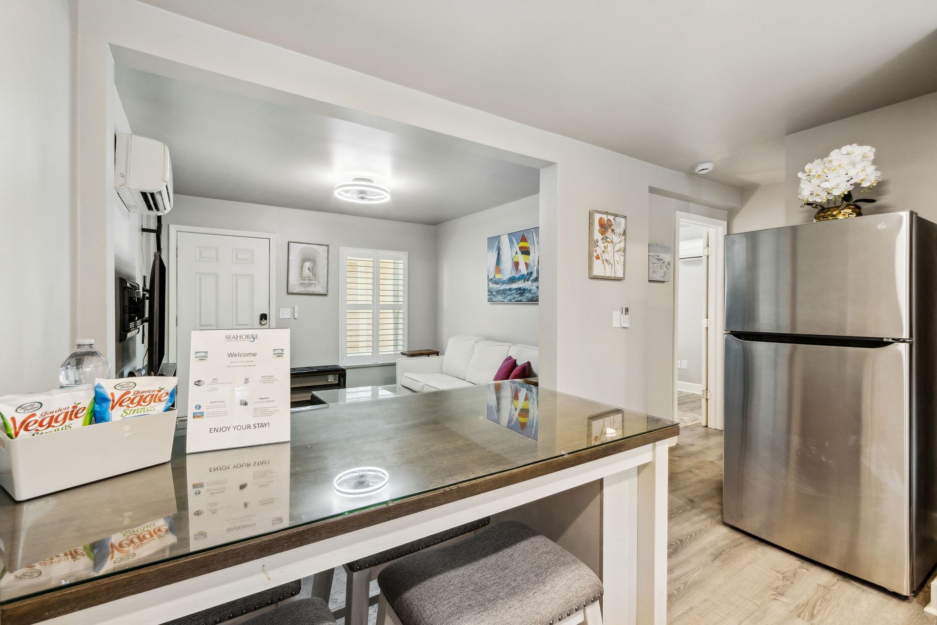 Dining room with a dining table/kitchen island combo and a full size refrigerator