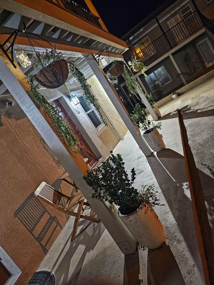 A patio with a lot of potted plants and chairs at night at the Beach 5 Villas in Fernandina beach, FL