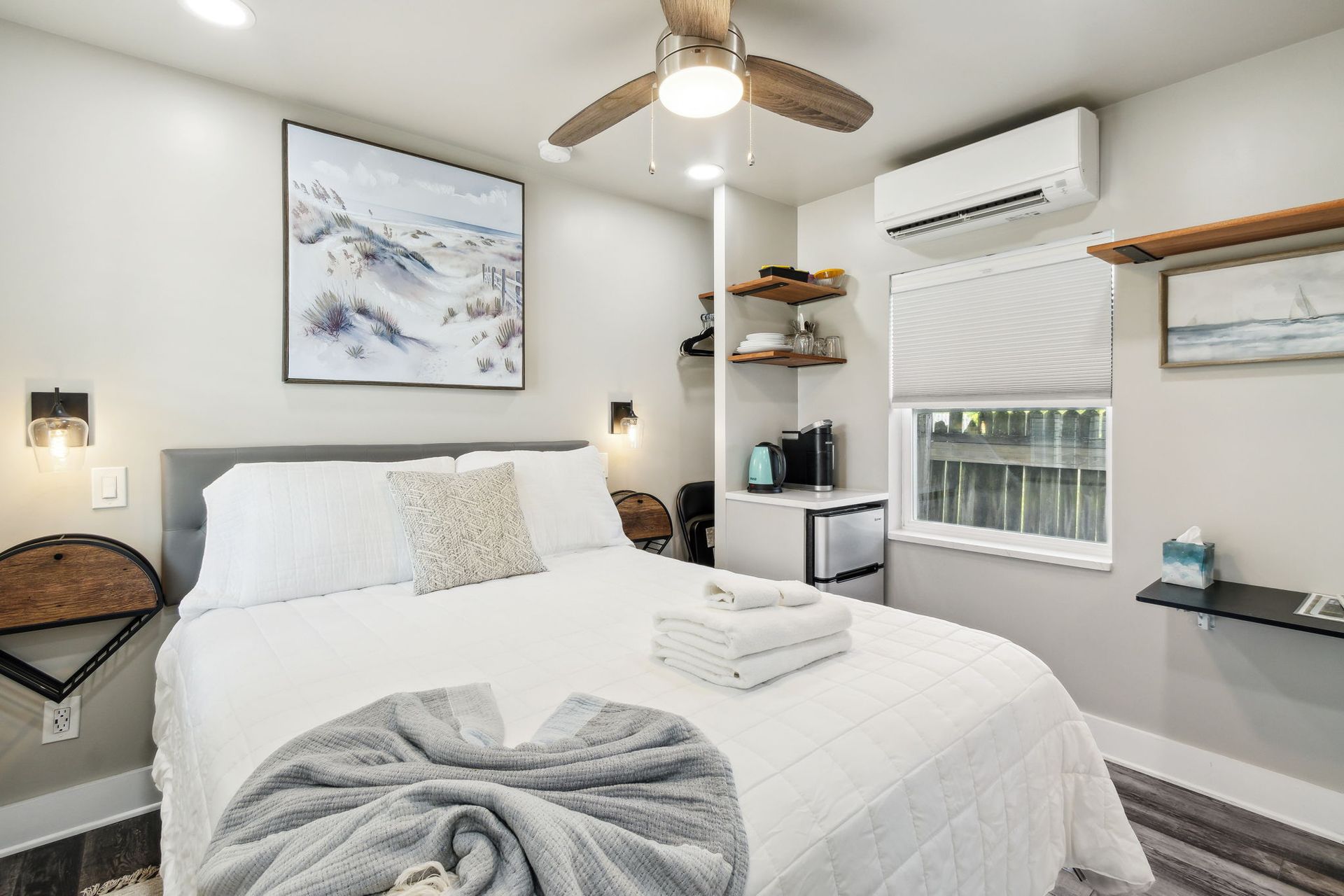 A bedroom with a bed and a ceiling fan.