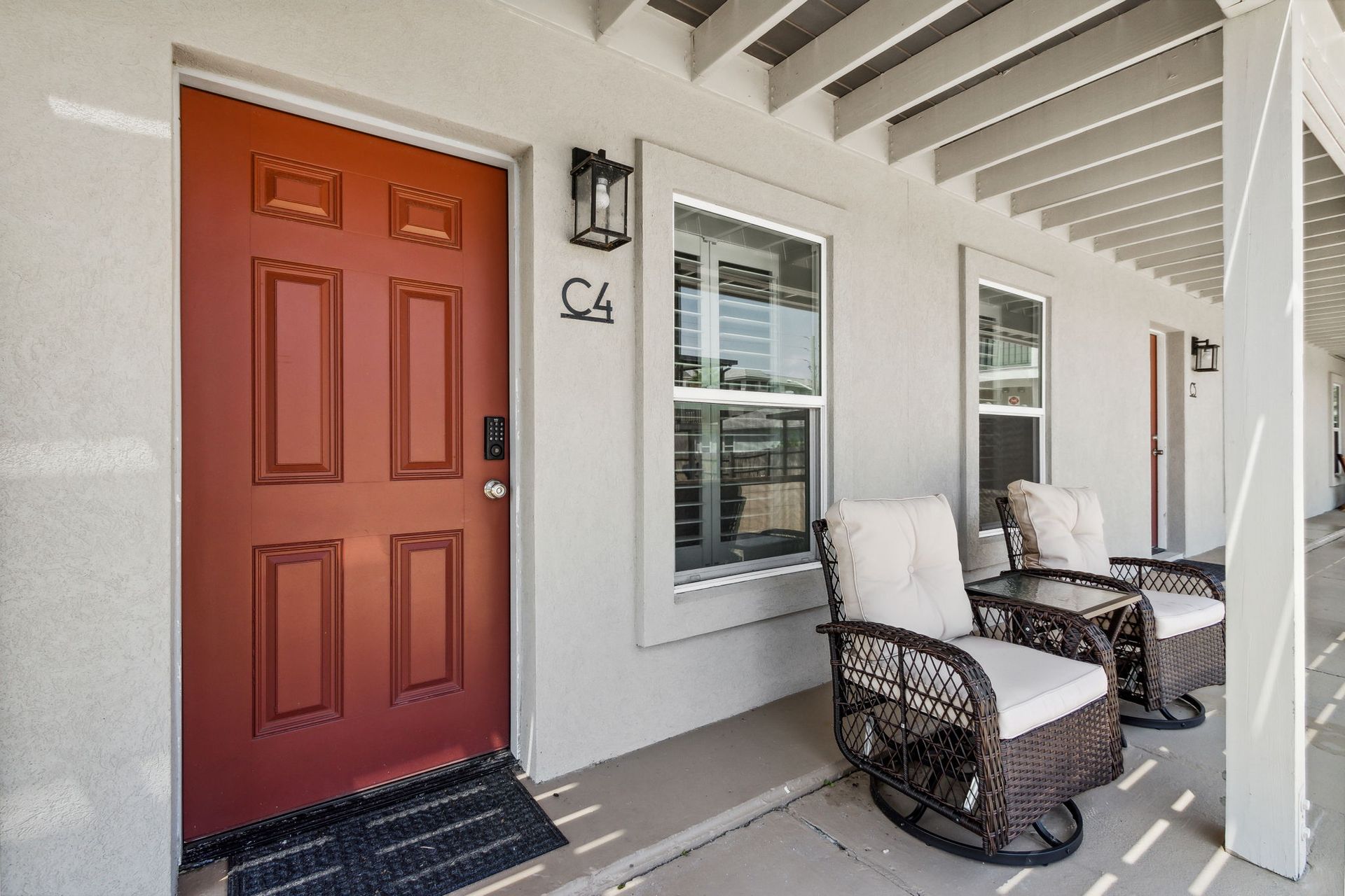 Balcony outdoor sitting area with two rocking chairs and a table 