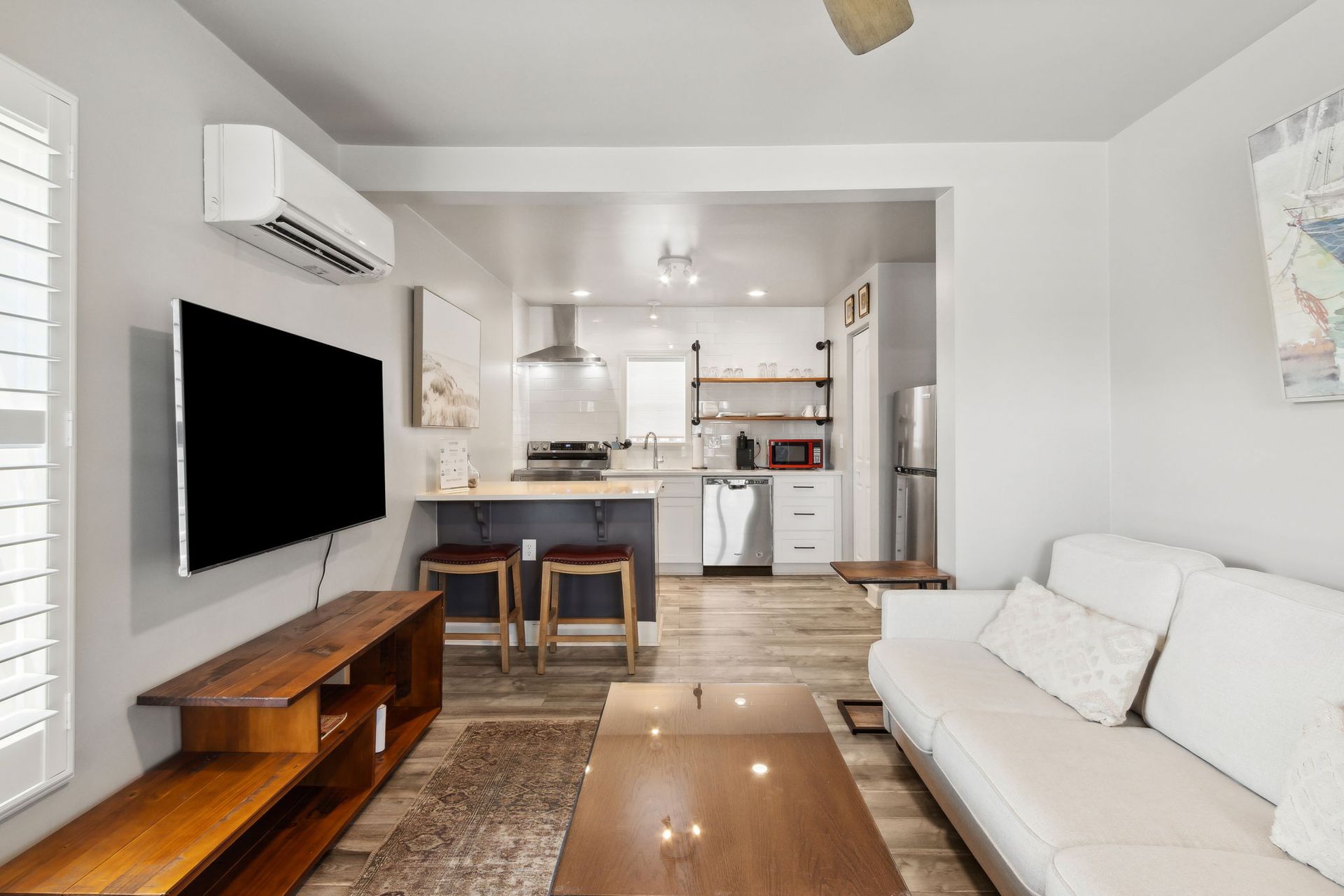 A living room with a sleeper sofa and a flat screen tv.