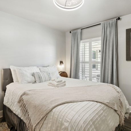 A bedroom with a large bed and a window