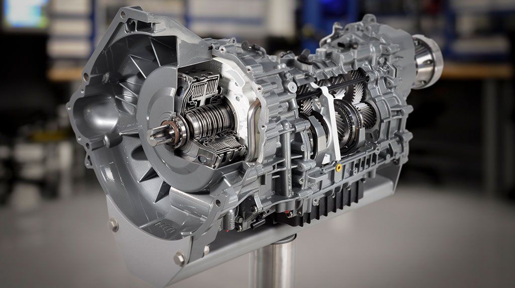 A close up of a gearbox on a stand in a room.