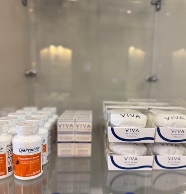 Several boxes of viva eye powder sit on a glass shelf