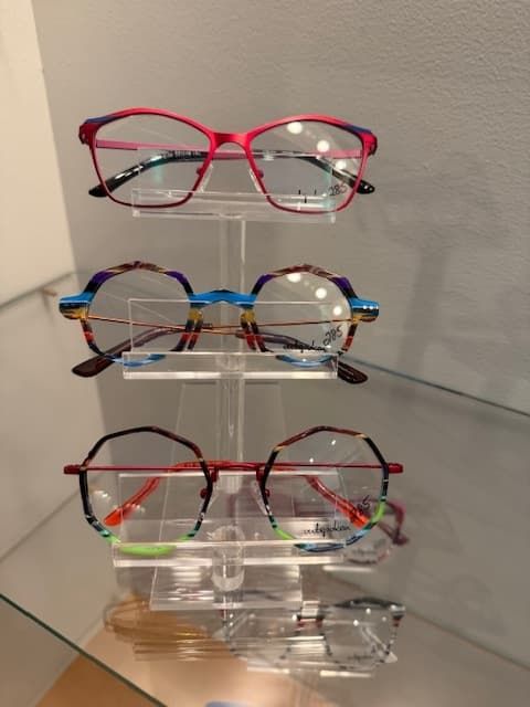 Several pairs of glasses are stacked on top of each other