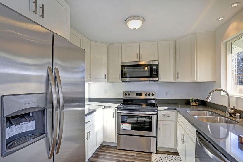 Bright modern kitchen with stainless steel appliances and white cabinets