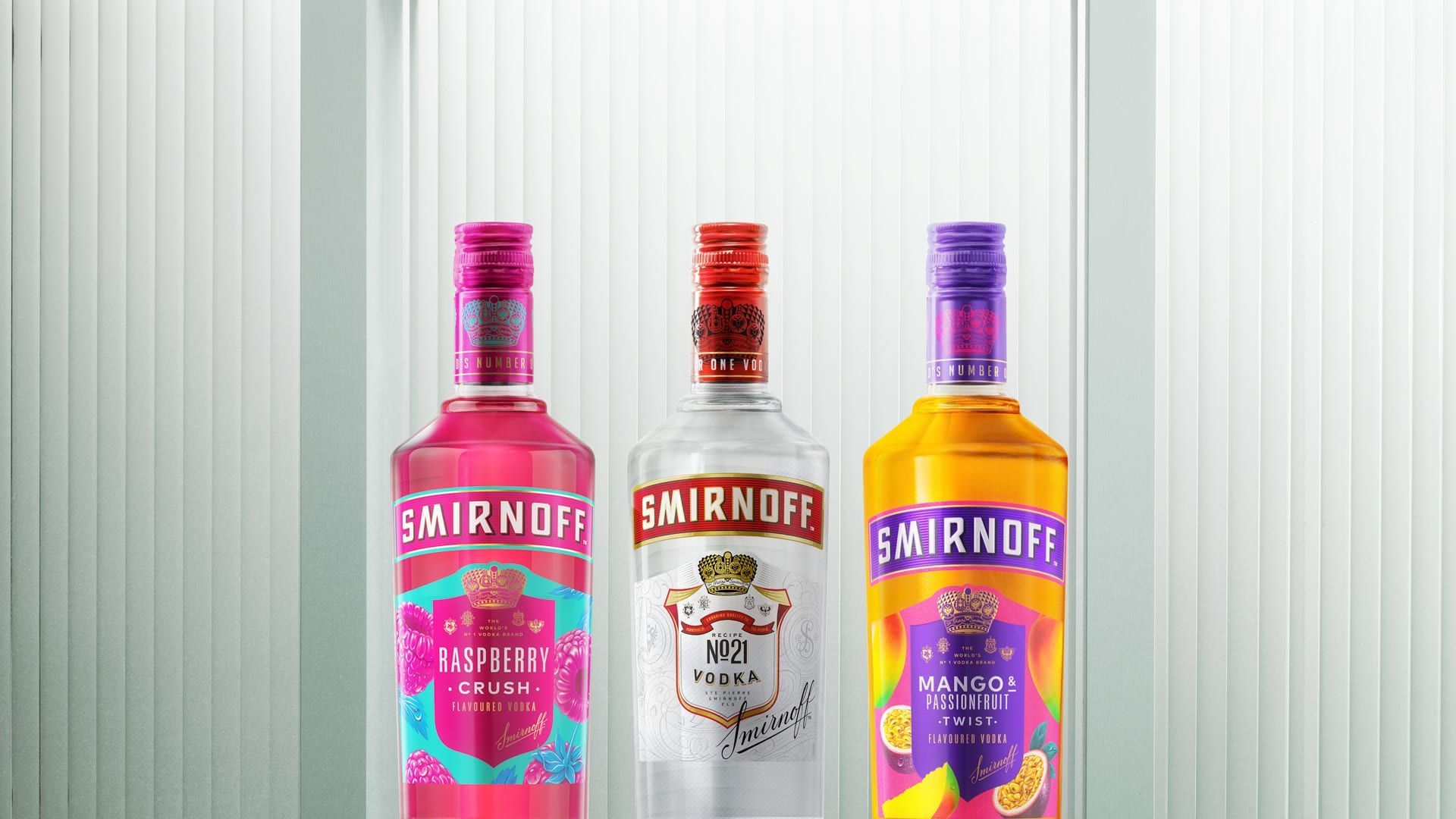 Three bottles of smirnoff vodka are sitting next to each other.