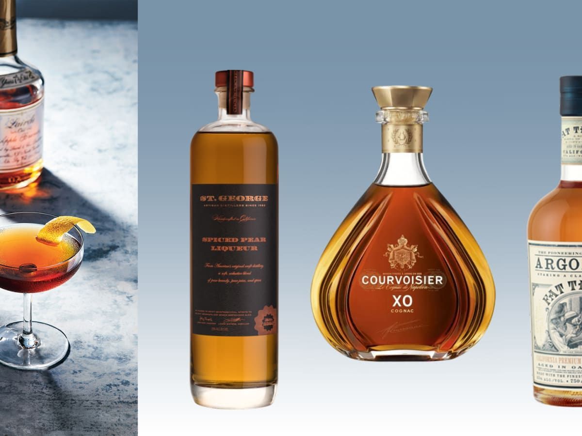 Three bottles of cognac are sitting next to each other on a table.