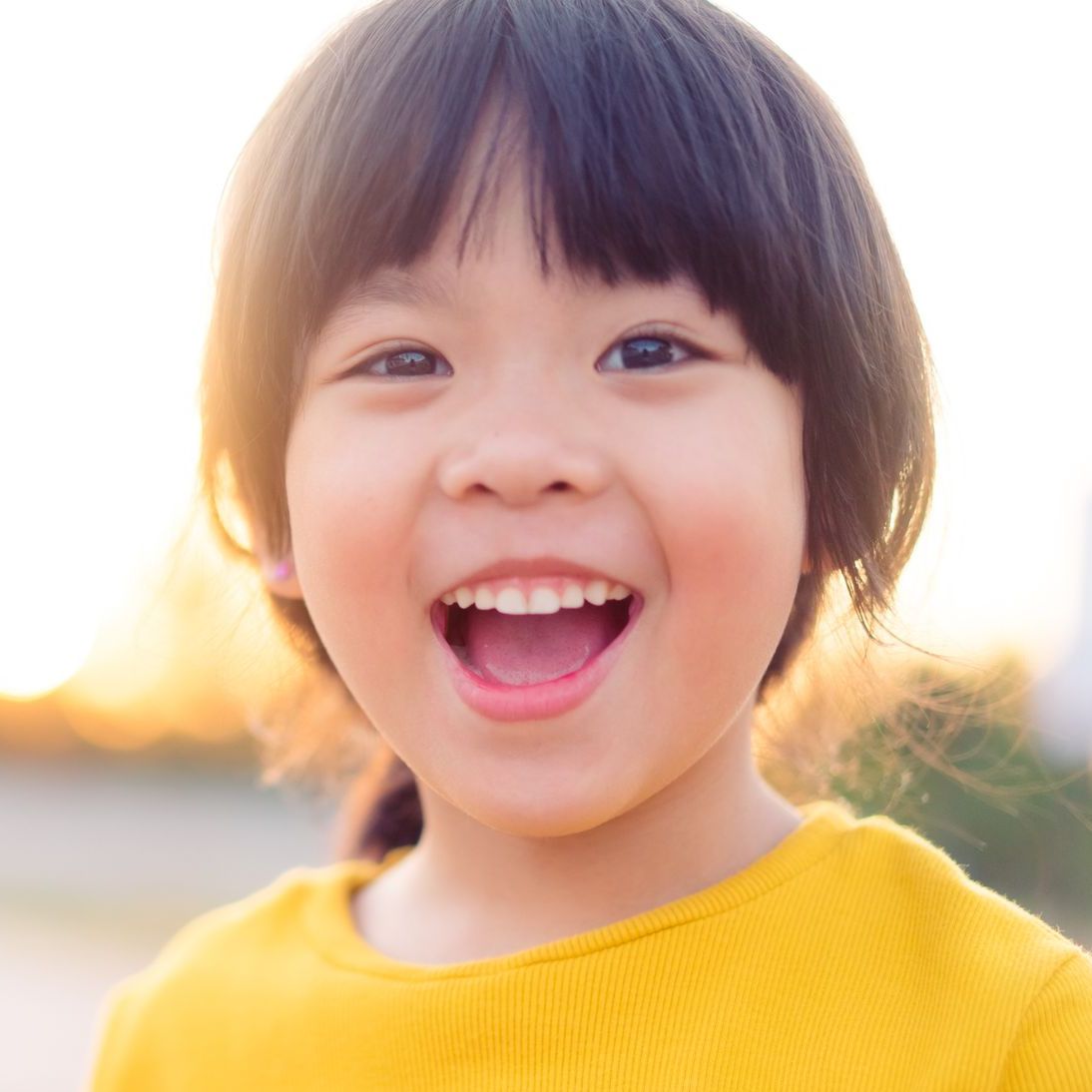 smilling child yellow shirt