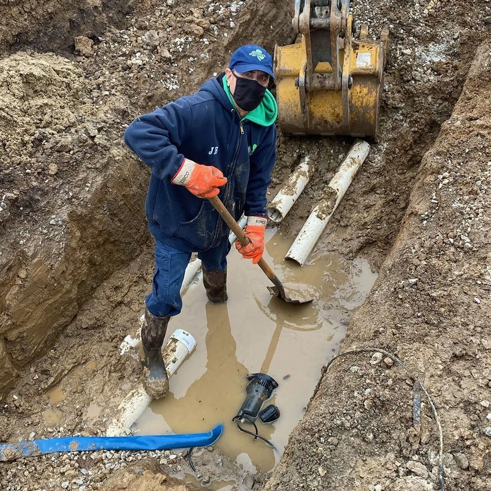 Man Installing New Drainage — St. Louis, MO — Shamrock Sewer & Drain Man Installing New Drainage — St. Louis, MO — Shamrock Sewer & Drain