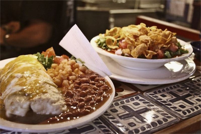 Delicious looking New Mexican food in the food window of restaurant.