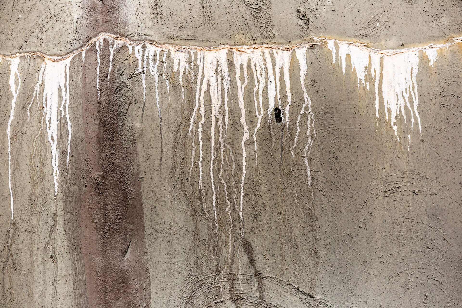 White drips on concrete wall White drips on concrete wall