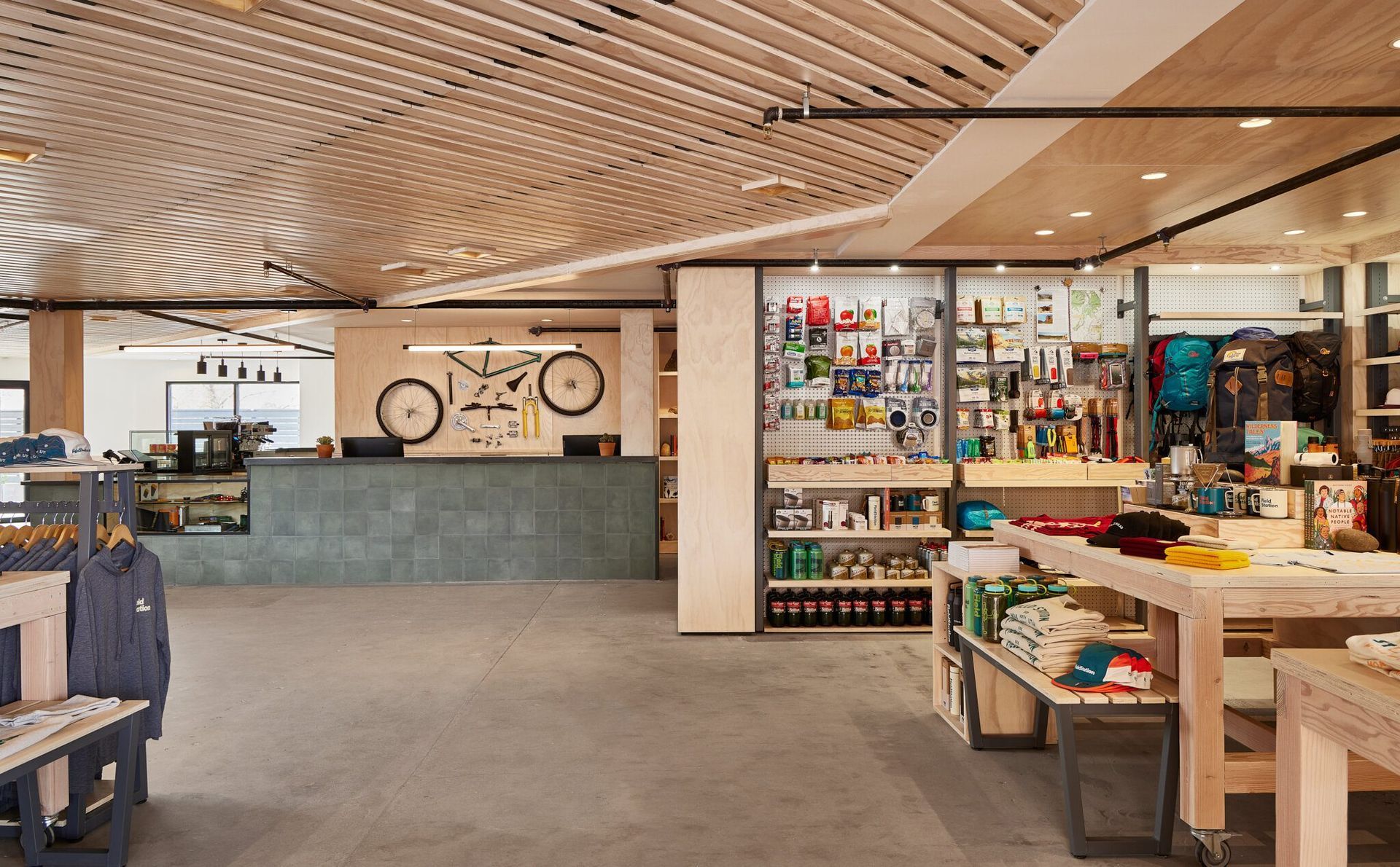 A store with a bicycle on the ceiling and a counter.