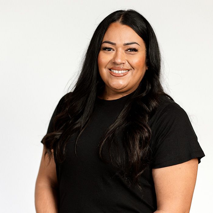A woman in a black shirt is smiling for the camera