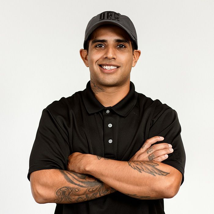 A man with a tattoo on his arm is wearing a hat that says ufc
