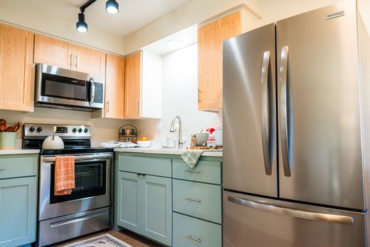 Bright modern kitchen with stainless steel appliances and light wood cabinets