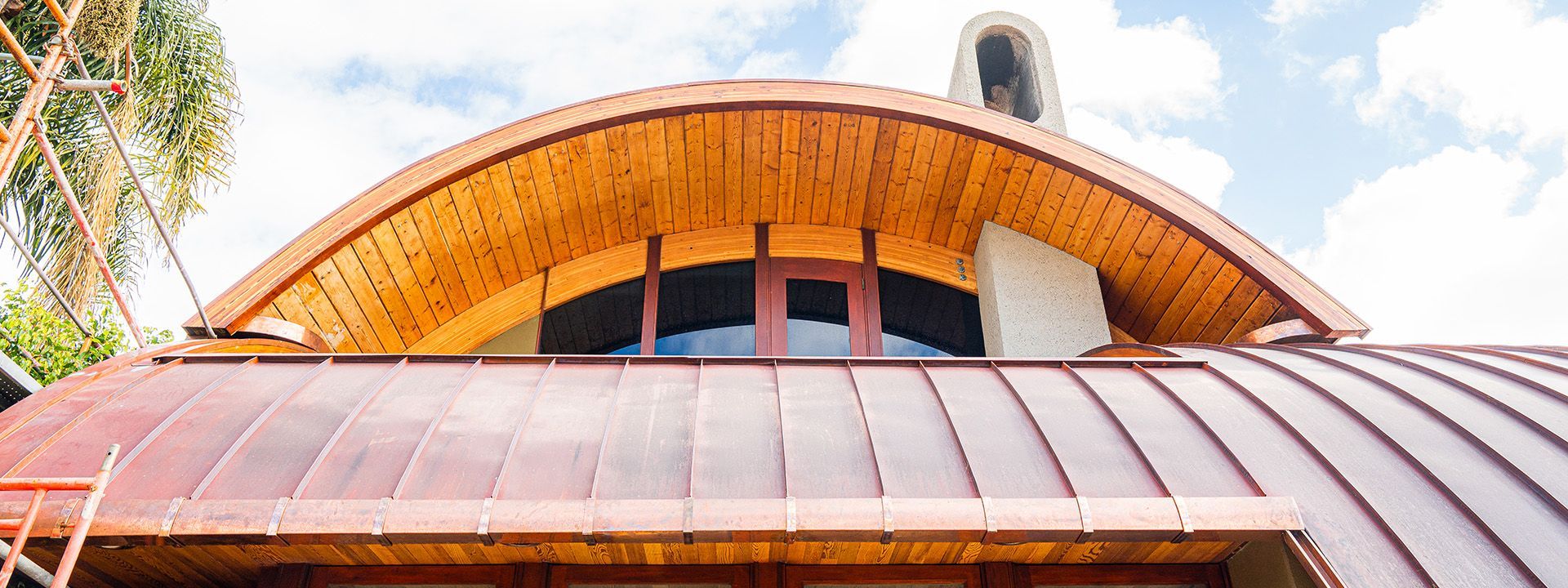 A house with a wooden roof and a copper roof.