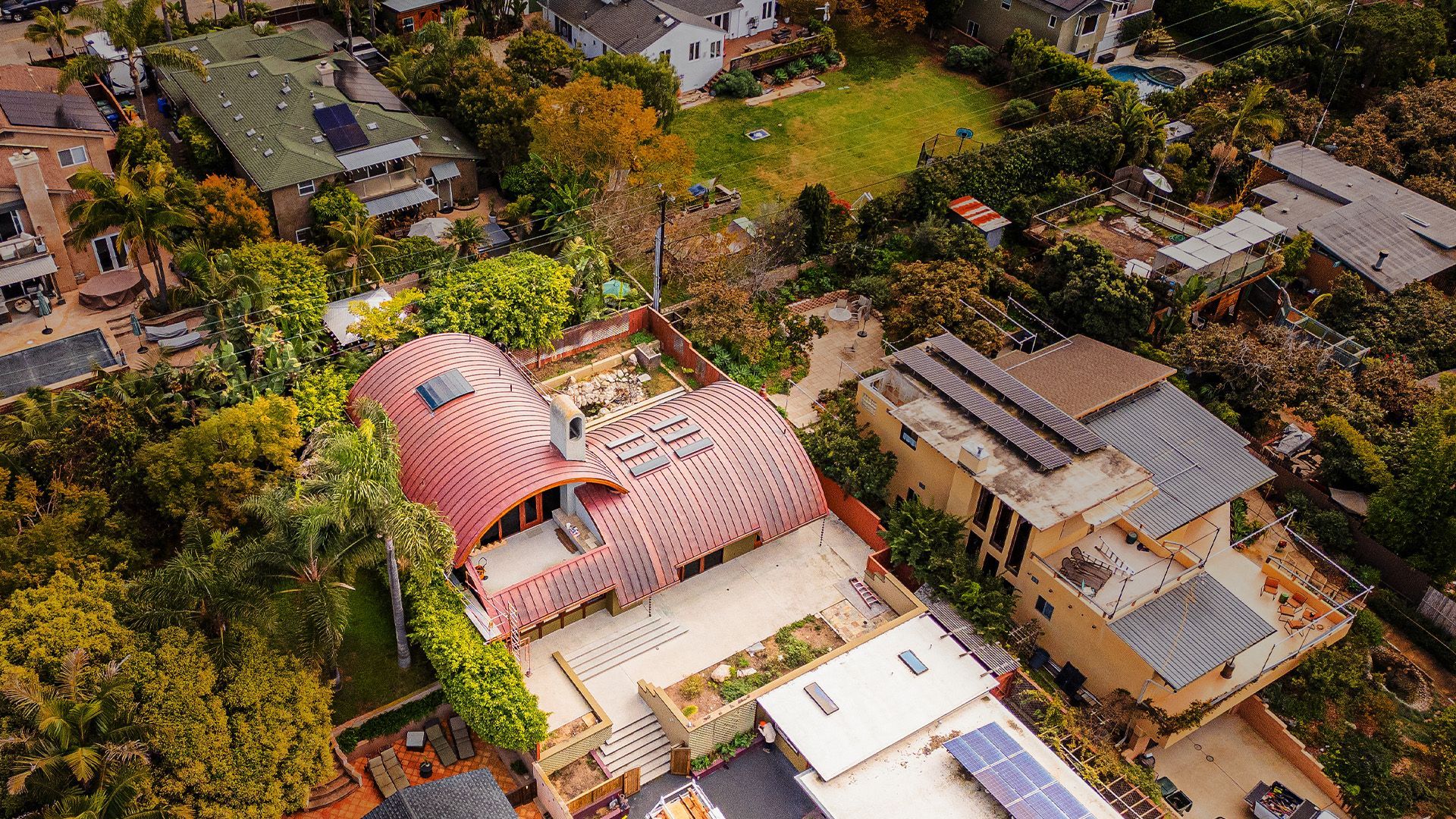 An aerial view of a residential area with lots of houses and trees.