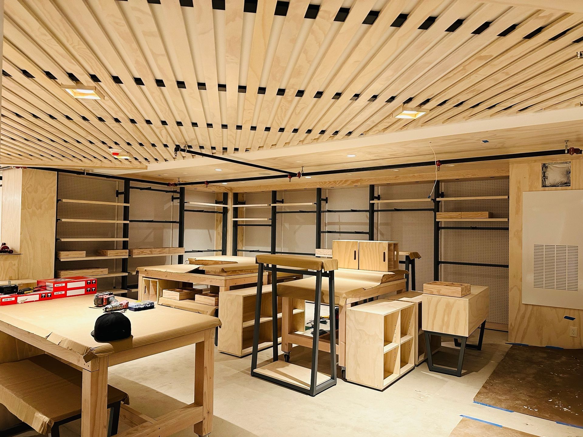 A room with a lot of wooden tables and shelves