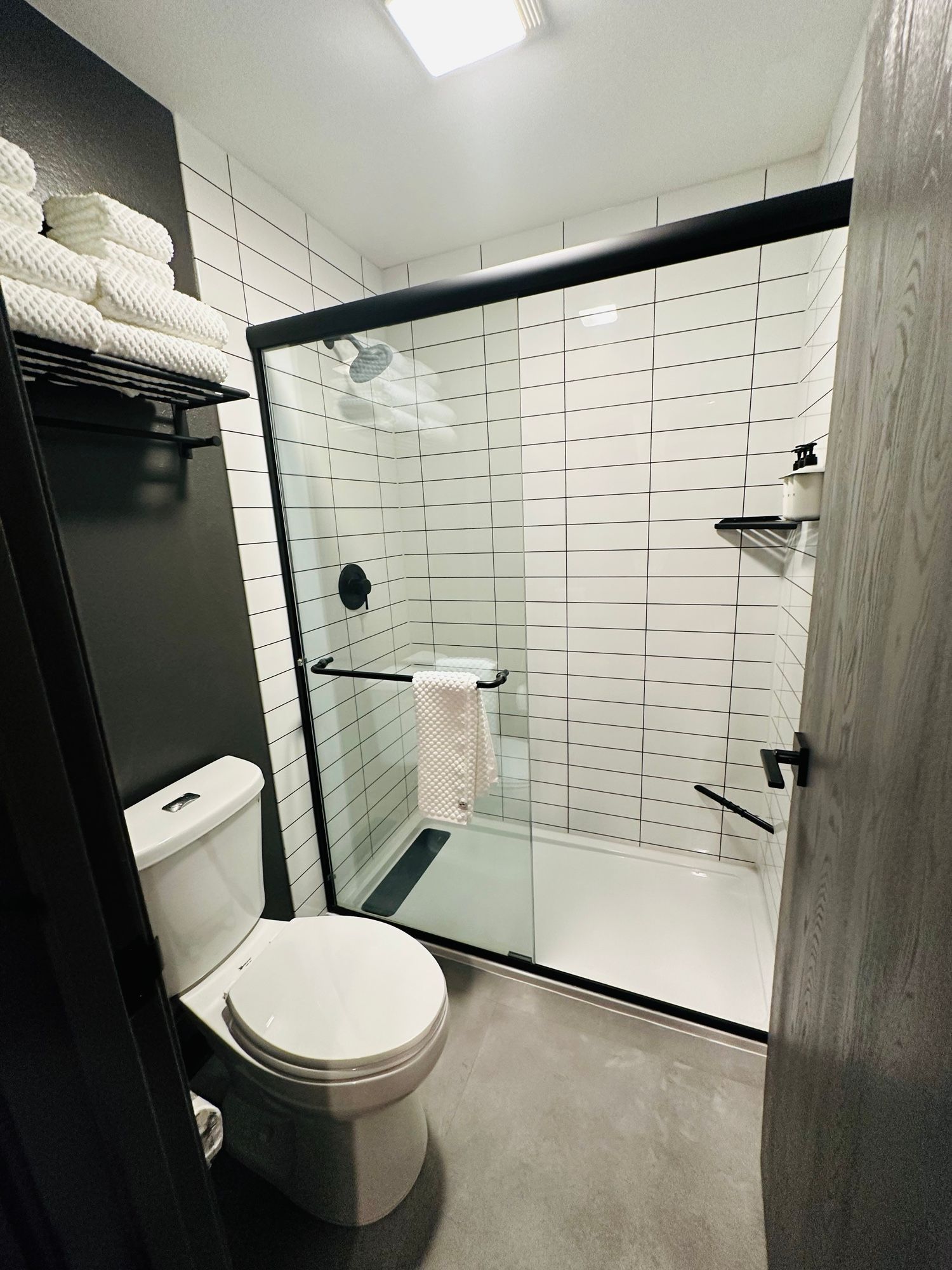 A bathroom with a toilet , shower and bathtub.