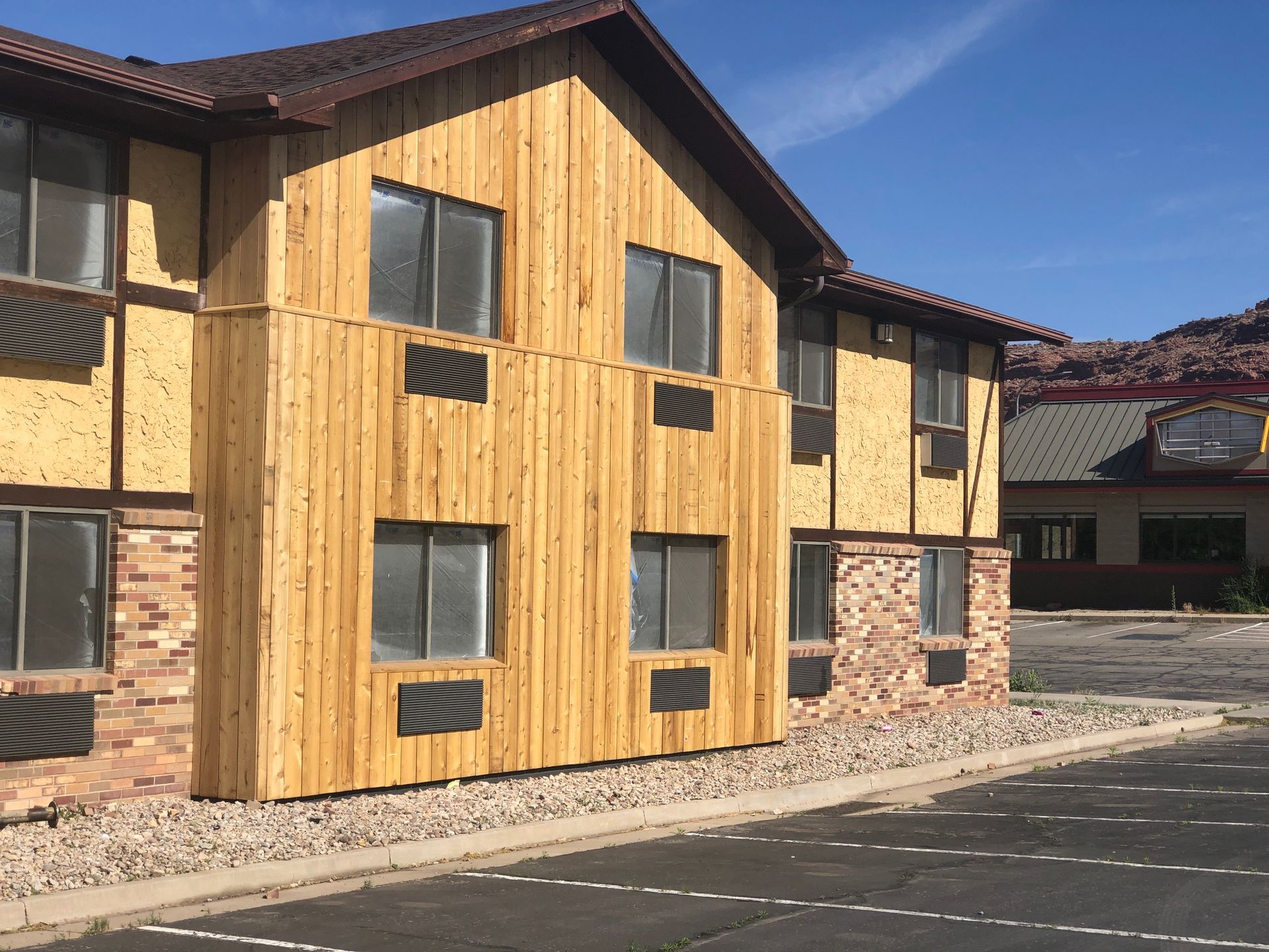 A building with a wooden facade and a lot of windows