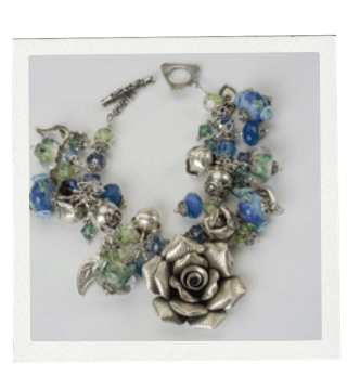 Silver charm bracelet with a large rose and blue/green beads.