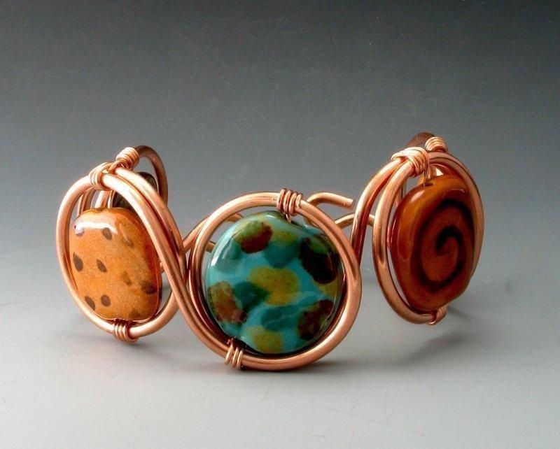 Copper wire bracelet with three colorful, round beads.