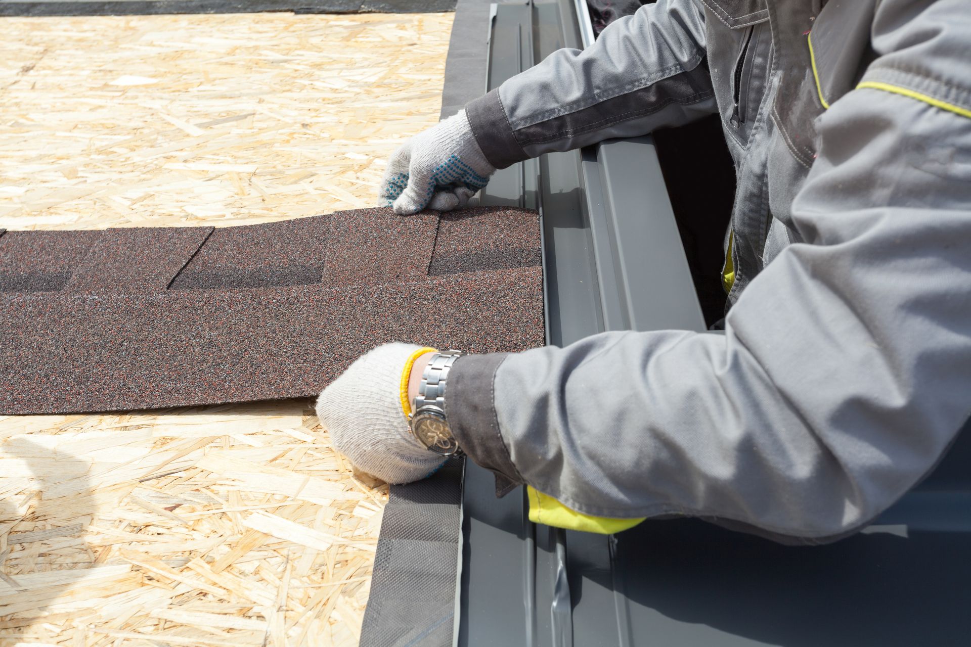 Close-up of asphalt shingle installation during a high-quality residential roofing replacement.
