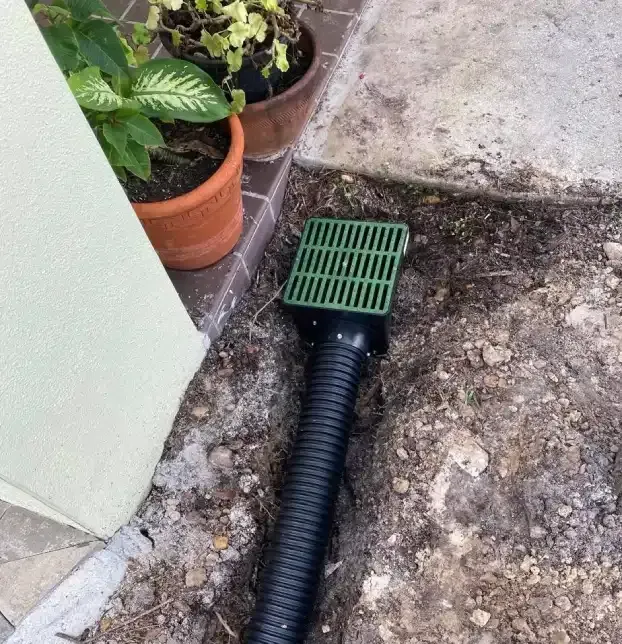 Catch basin connected to underground drainage pipe during a Fort Myers landscape drainage installation