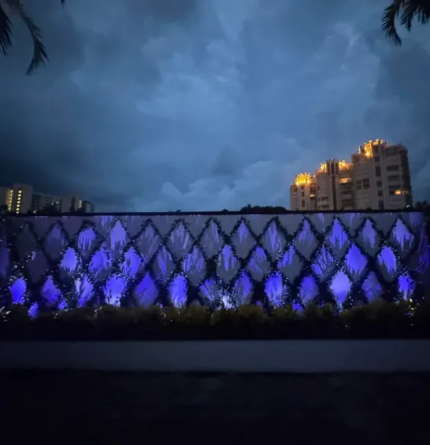 Outdoor wall lighting illuminating an exterior wall and surrounding landscape in Fort Myers, FL