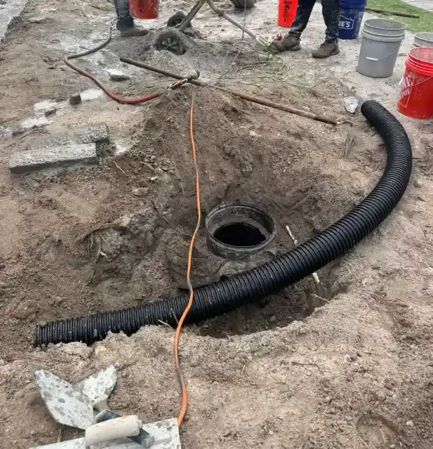 Stormwater drainage pipe being installed near a pond in Fort Myers, FL