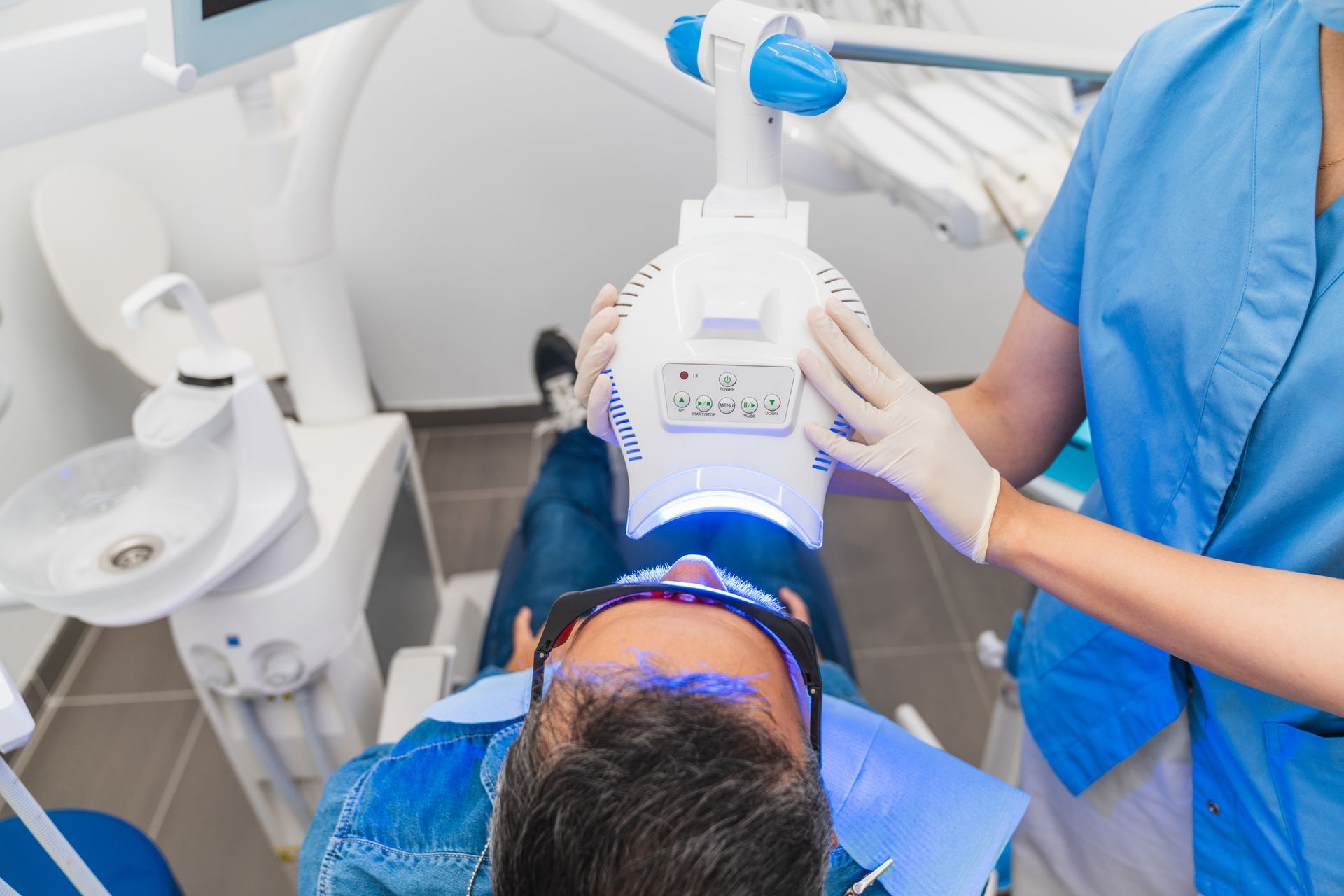A man is getting his teeth whitened.