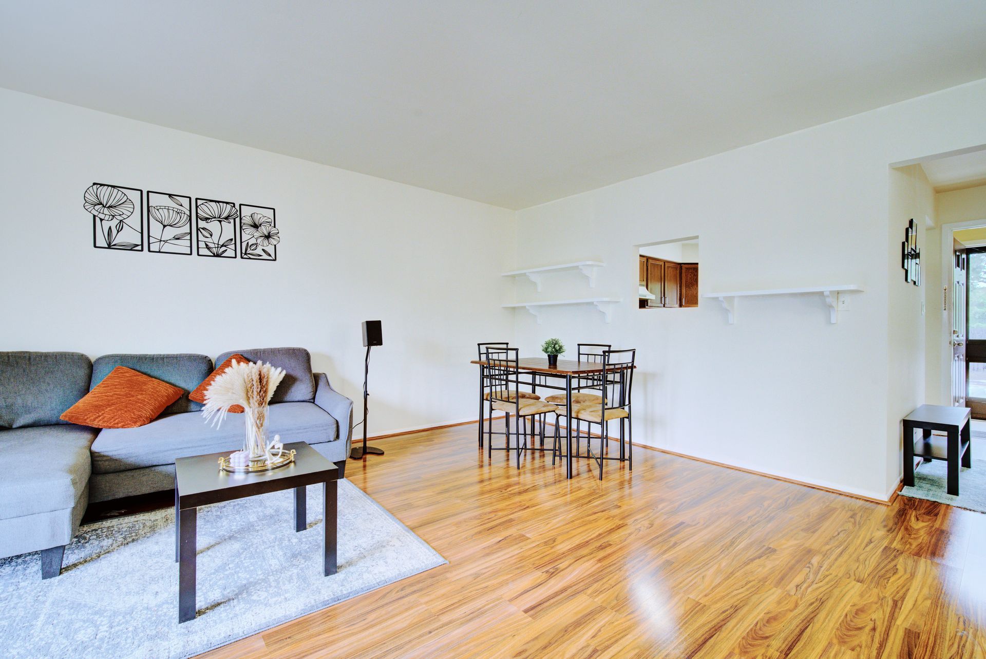 A living room with a couch , table and chairs.