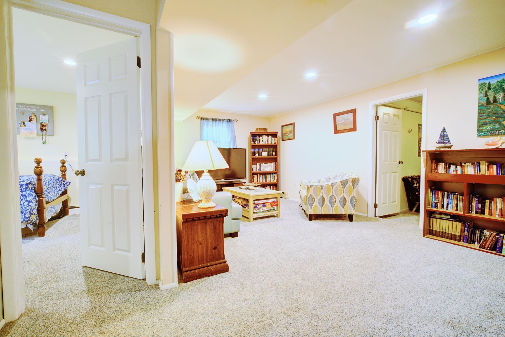 A living room with a couch and a bookshelf