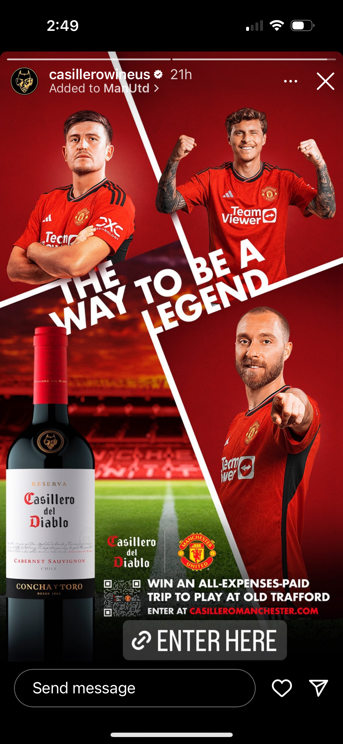 A bottle of wine is next to a group of soccer players.