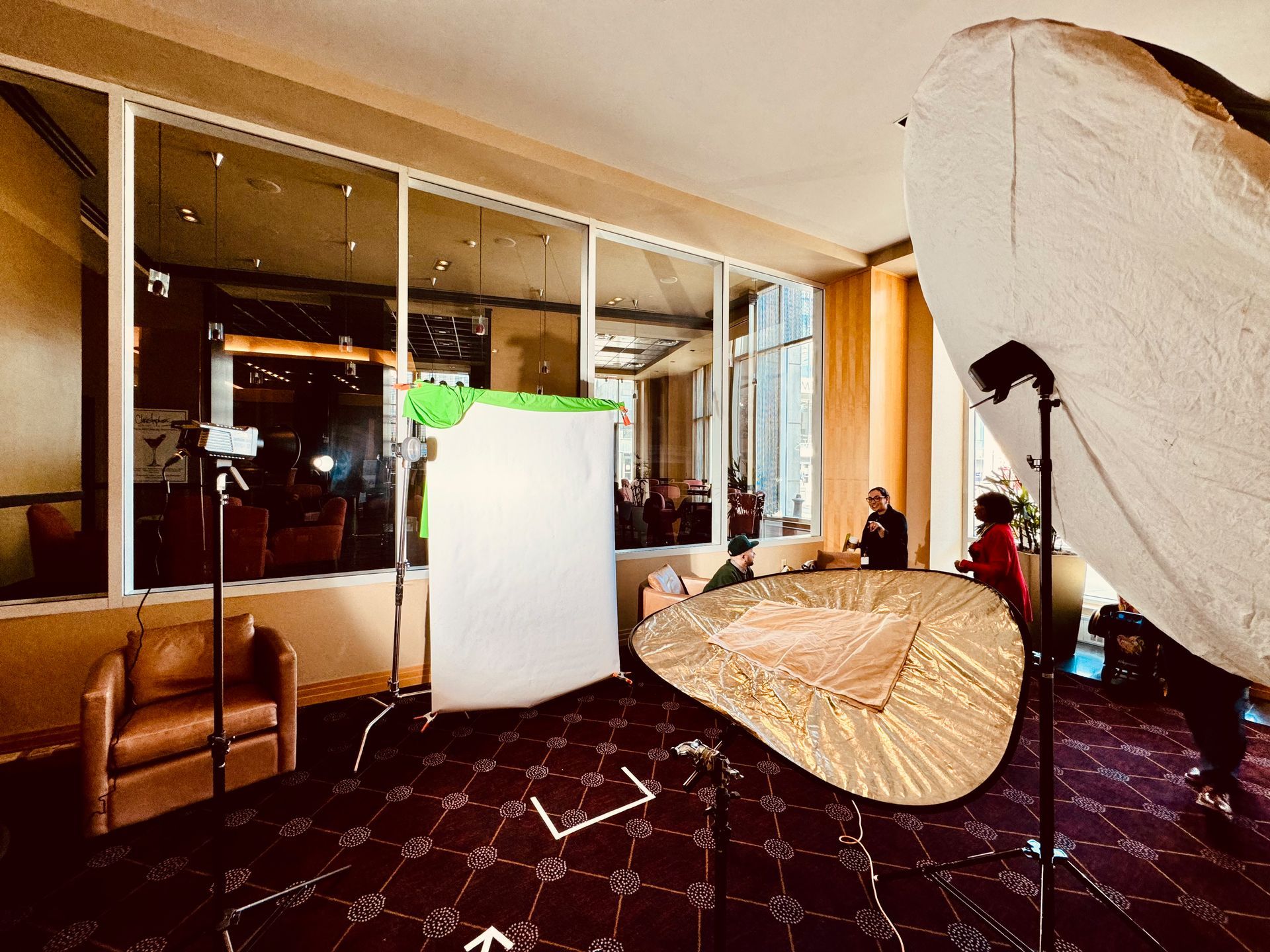 Interior room with photography equipment set up near window and seating.