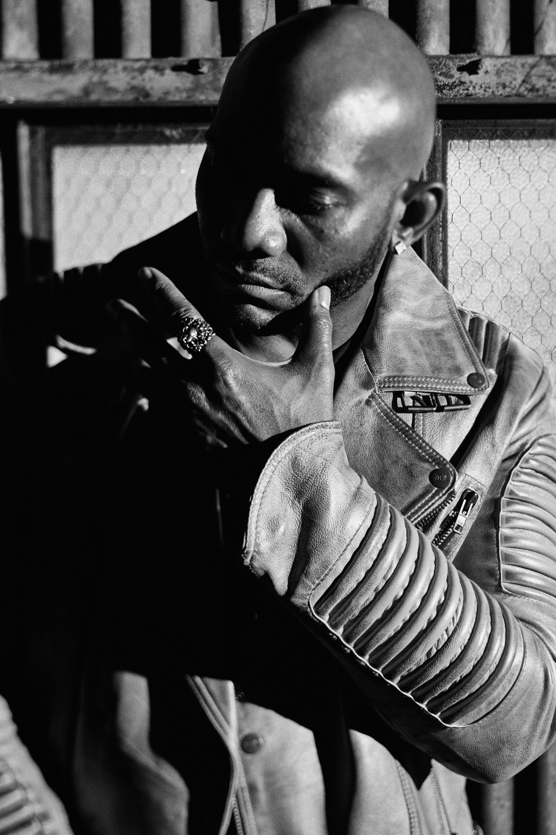 A black and white photo of a man wearing a leather jacket