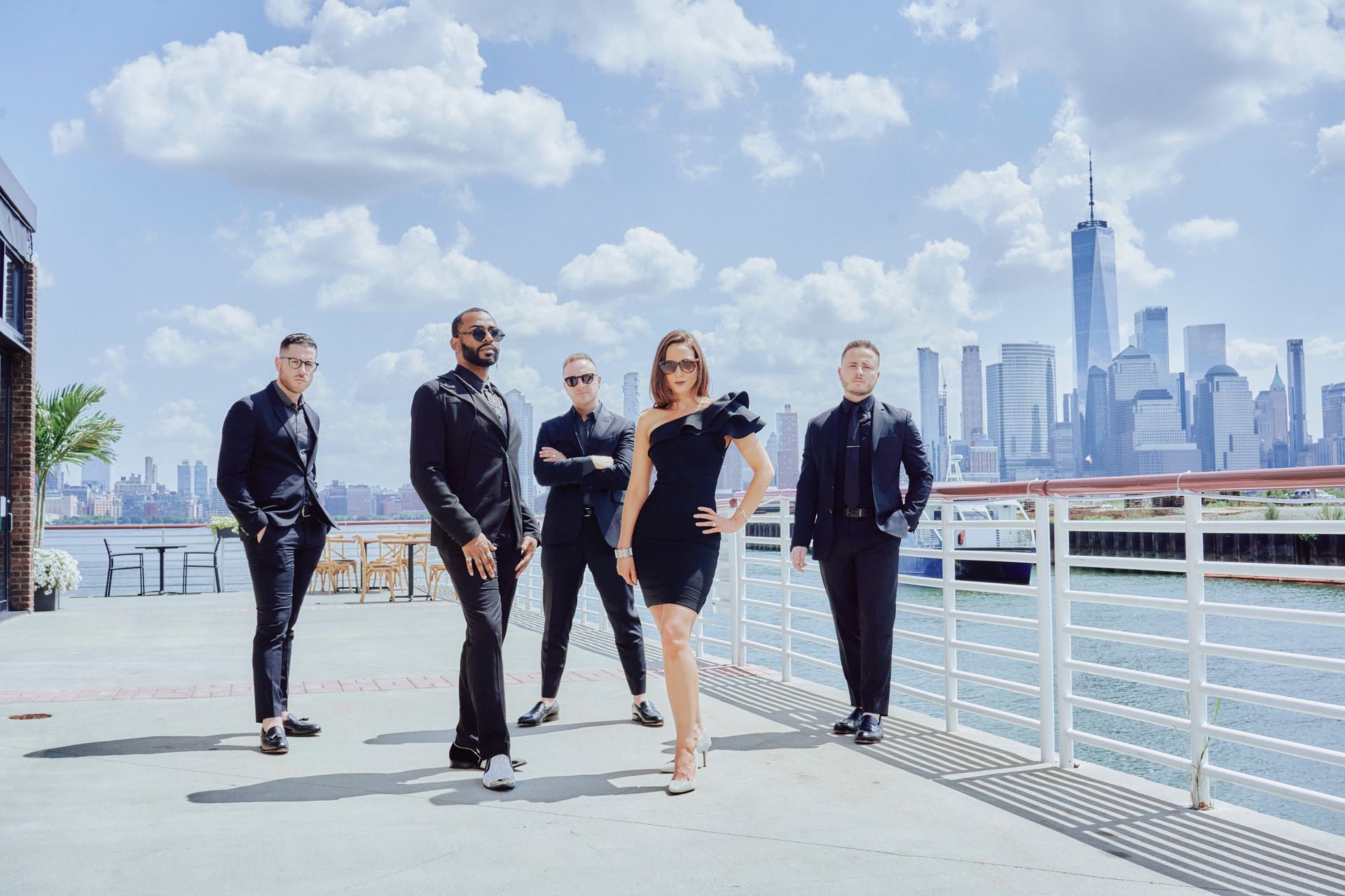 A group of people standing next to each other on a pier.