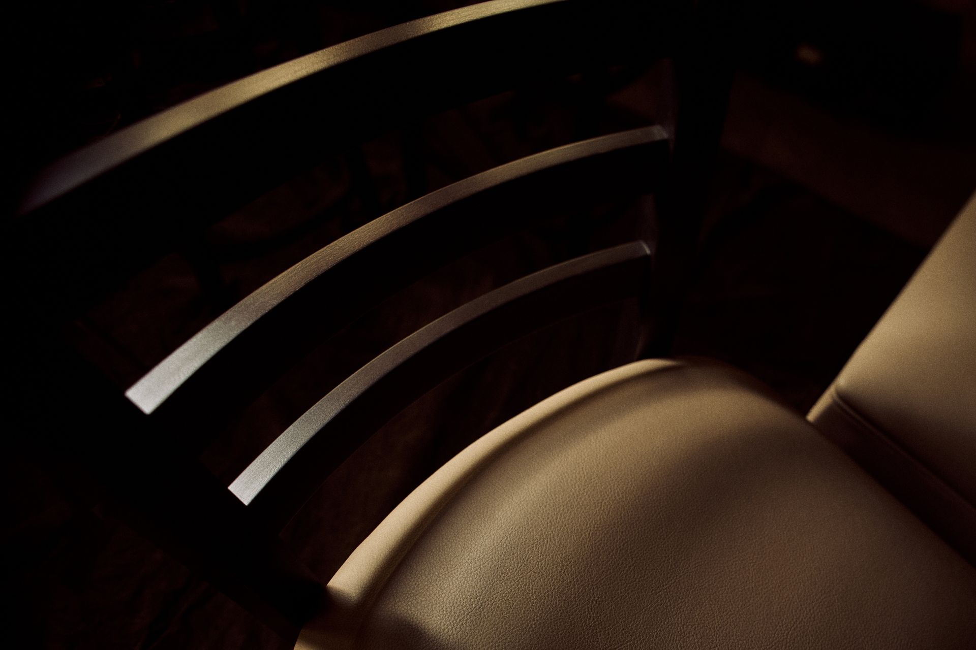 A close up of a chair in a dark room