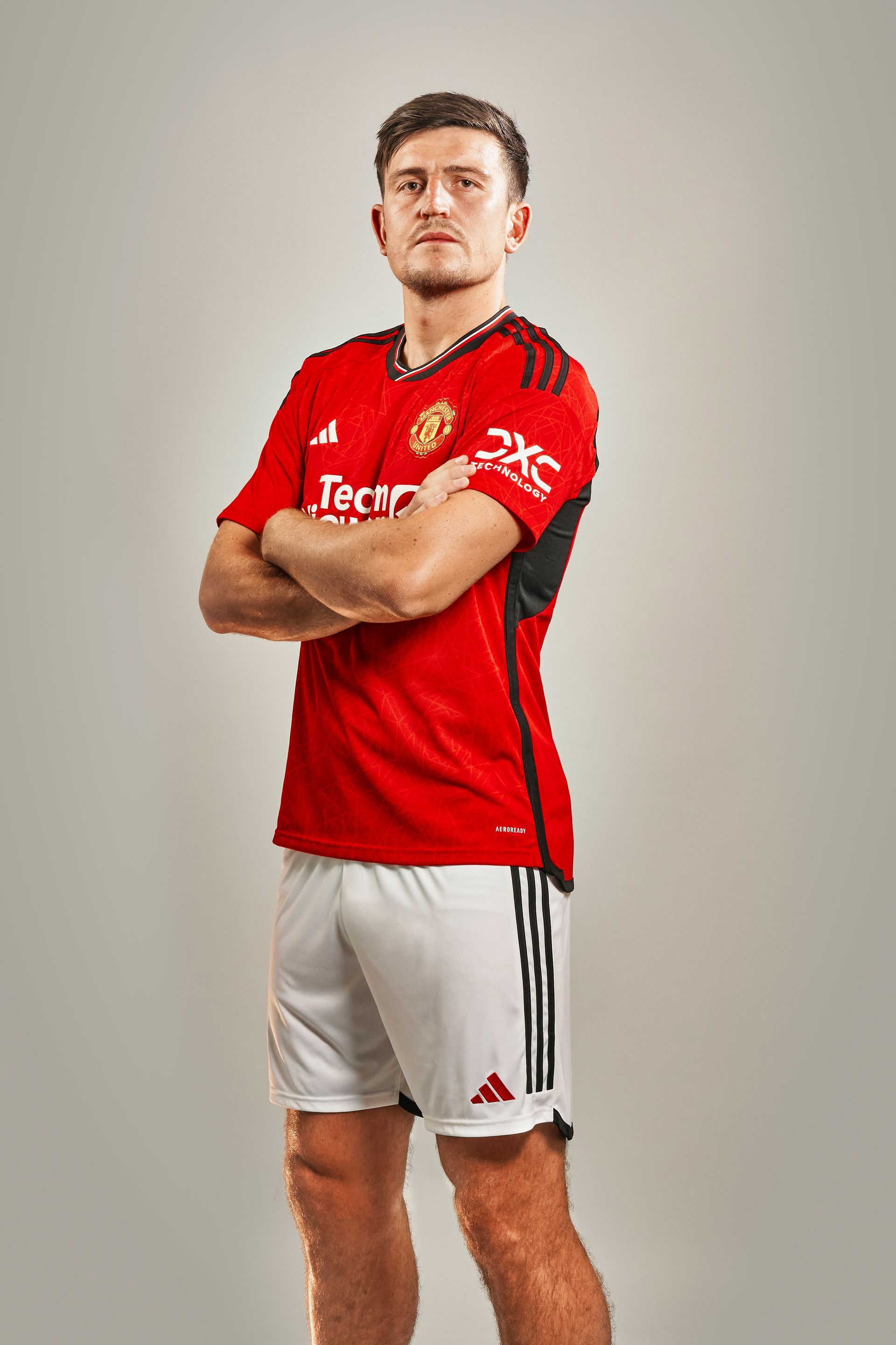 Soccer player Victor Lindelöf in Manchester United jersey, fists raised, smiling.