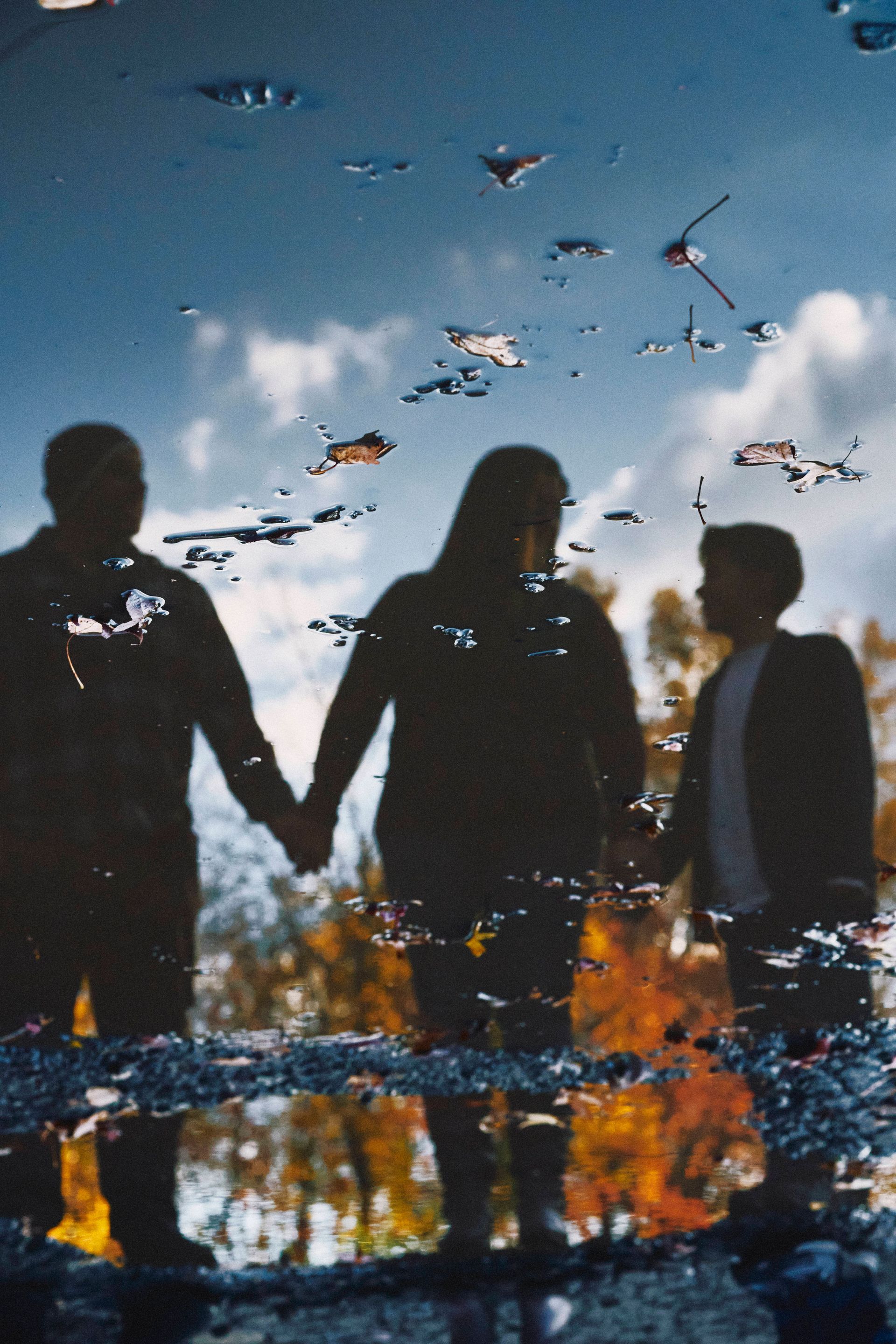 A group of people holding hands in a puddle of water