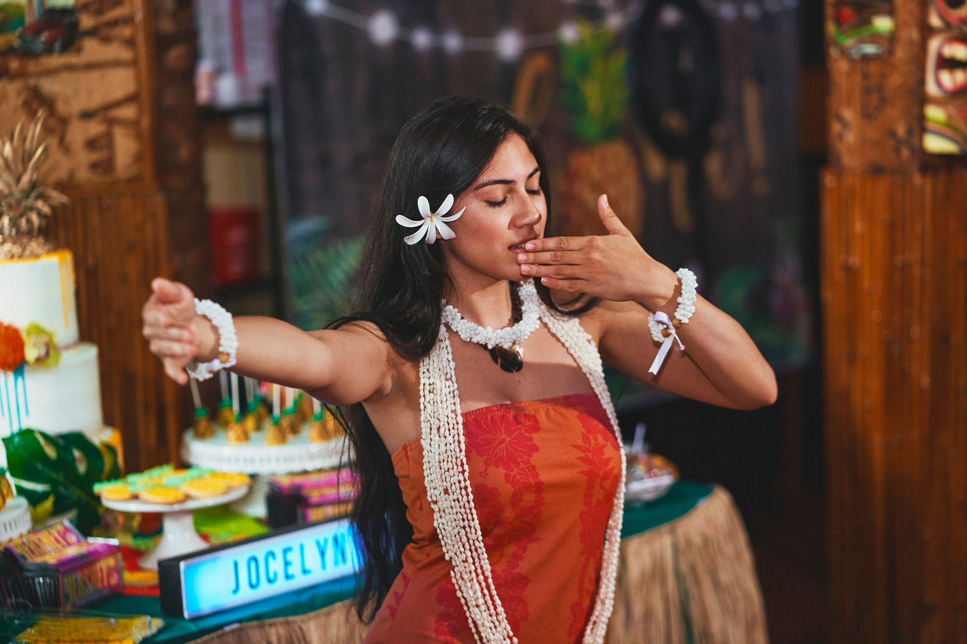 A woman dressed as moana is dancing in a room.