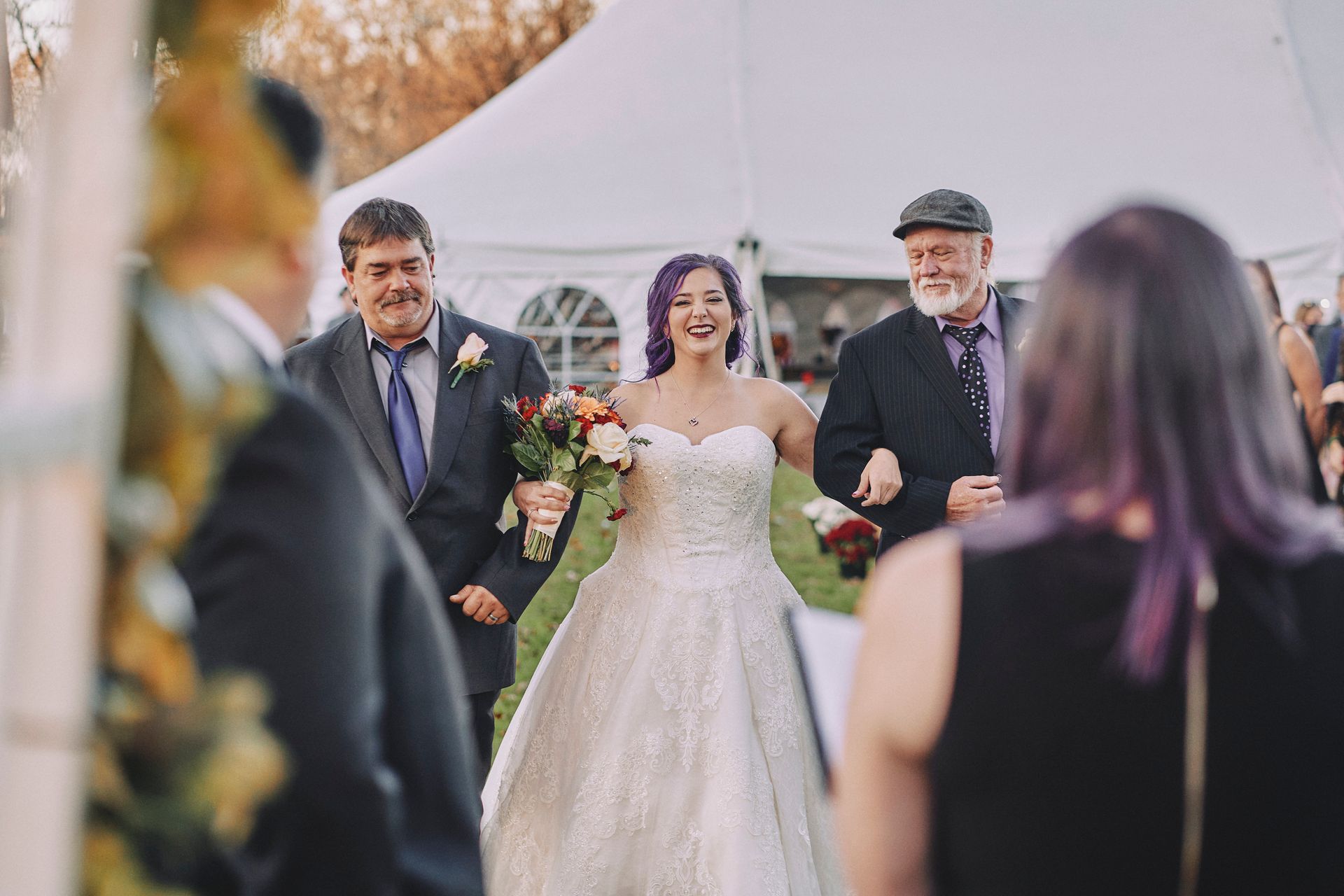 A bride and groom are walking down the aisle at their wedding.