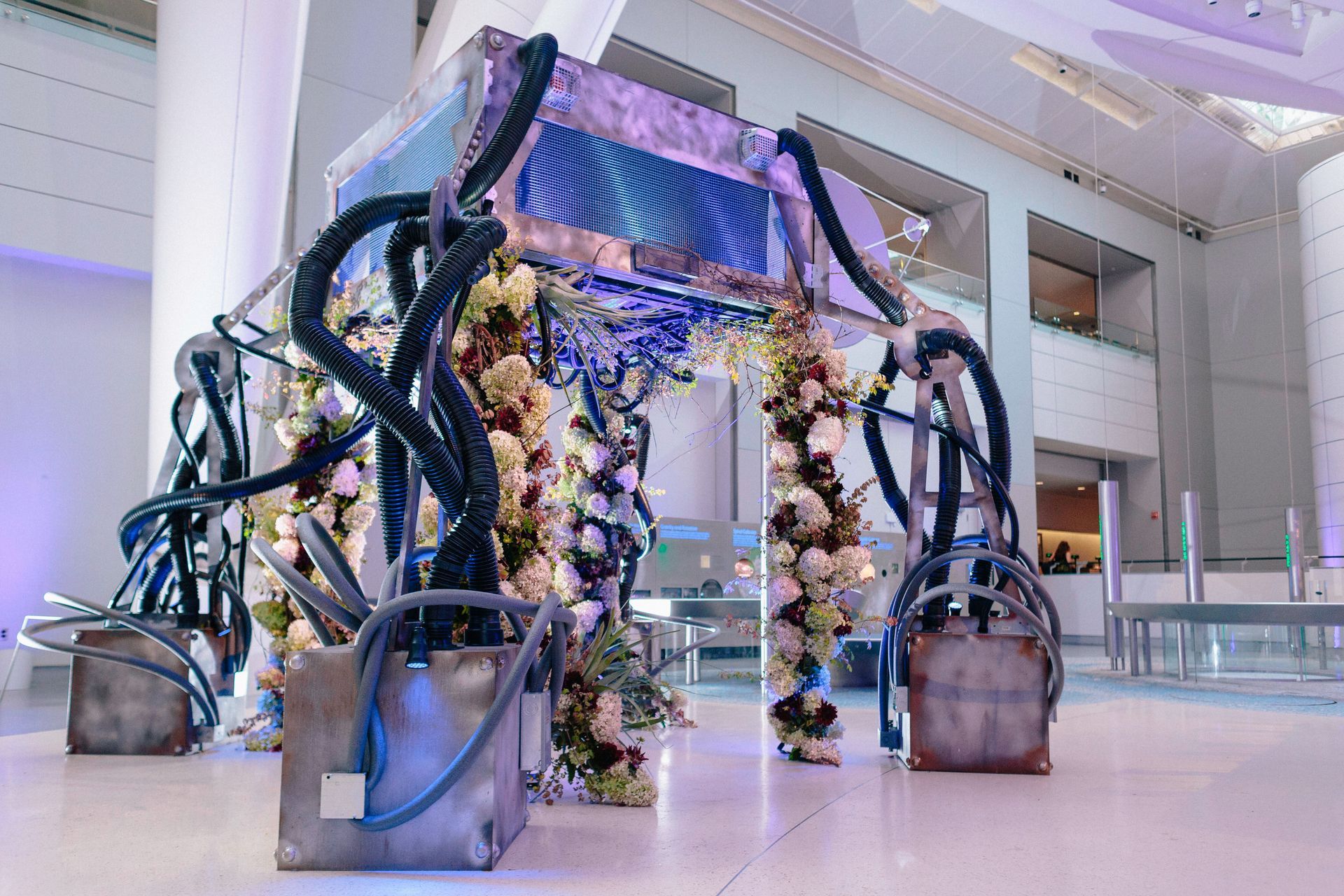 A large room with a floral archway in the middle of it.