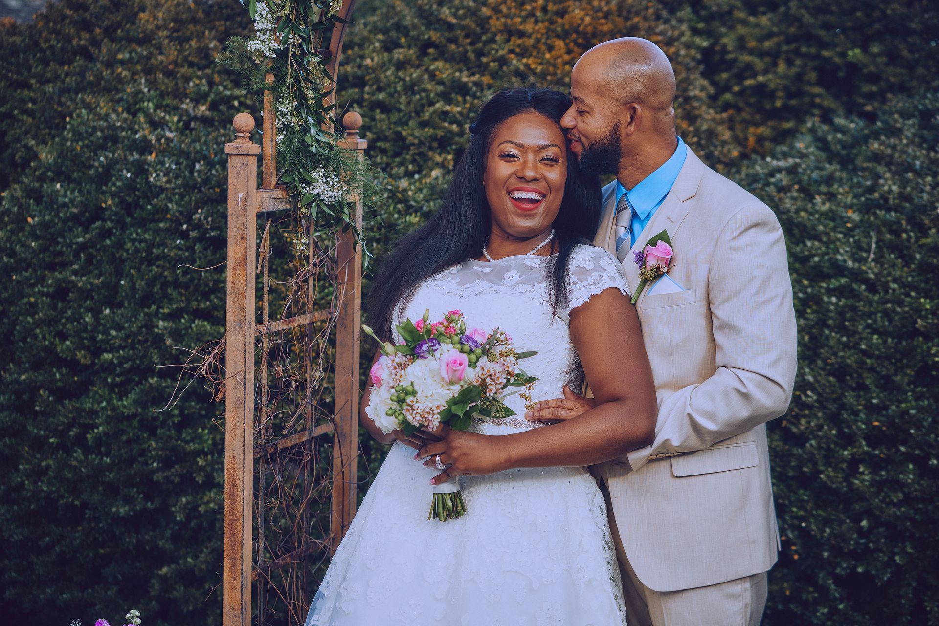 A bride and groom are posing for a picture on their wedding day.