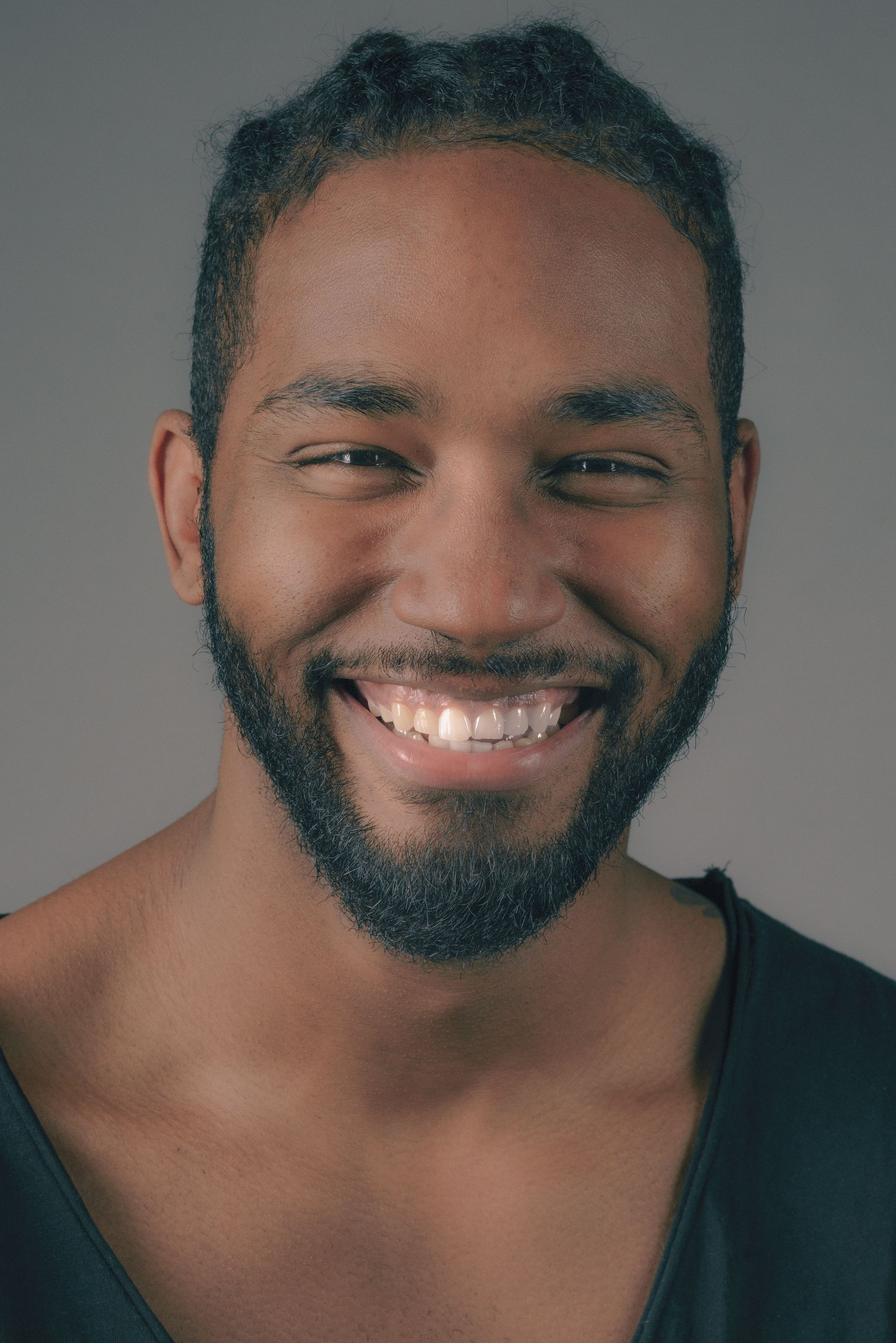 A man with a beard is smiling for the camera.